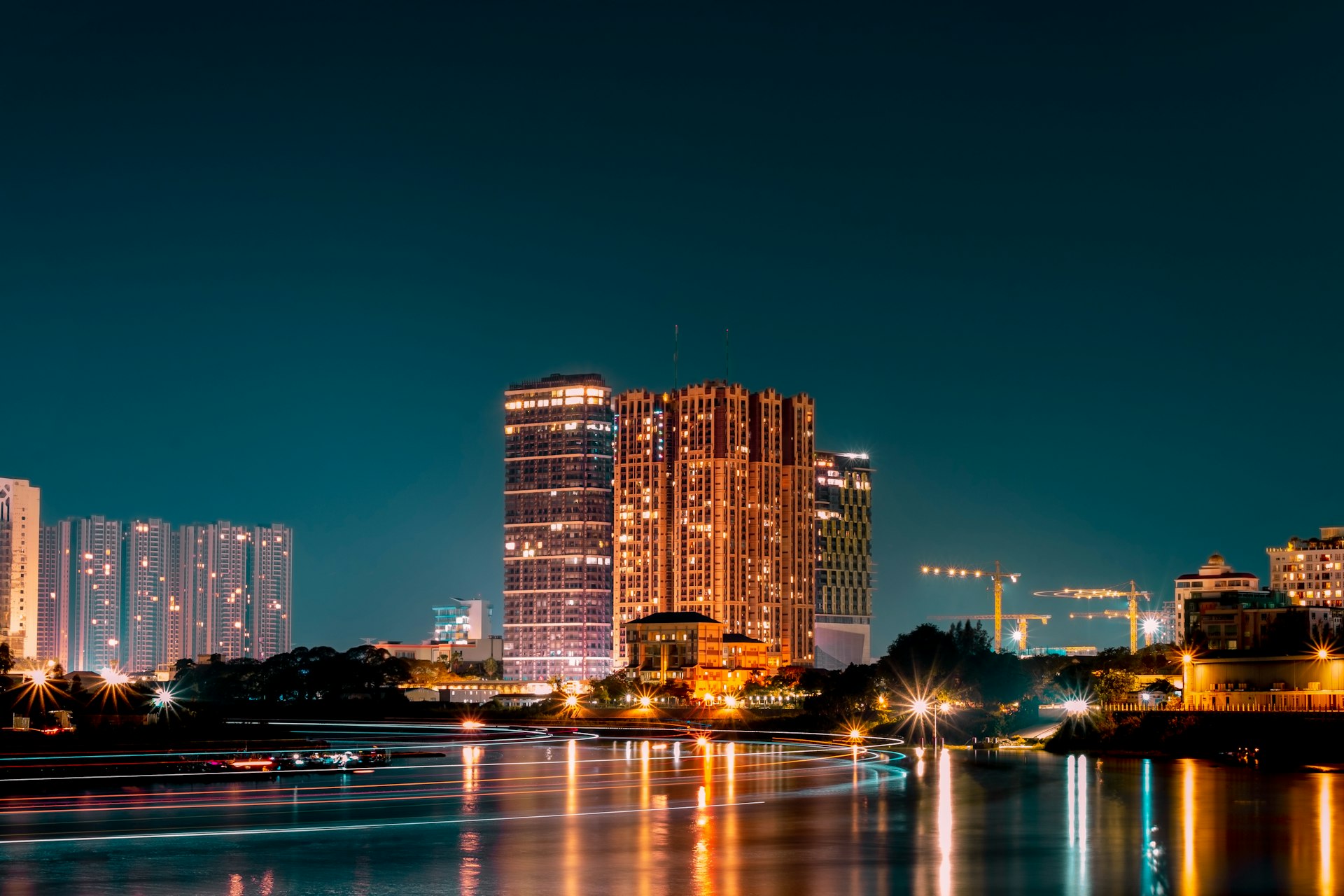 a city at night with a river running through it